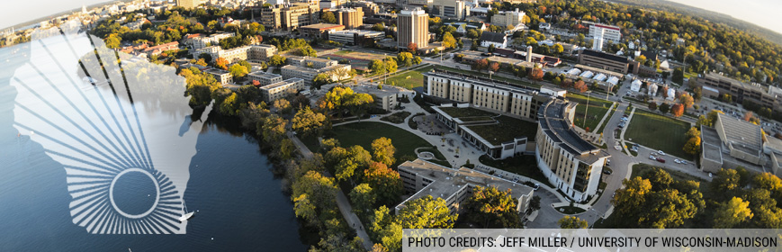 An arial shot of UW–Madison campus and the shore of lake Mendota