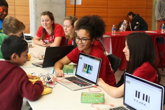 A visitor playing a melody on a banana pian