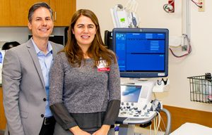 Guelay Bilen-Rosas and Humberto Rosas standing in a medical exam room