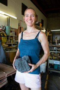Alisa Toninato holding a chunk of coke in a workshop