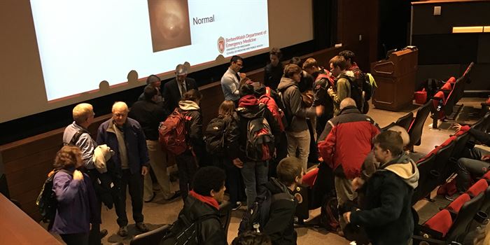 Students surround Berbee in a lecture hall