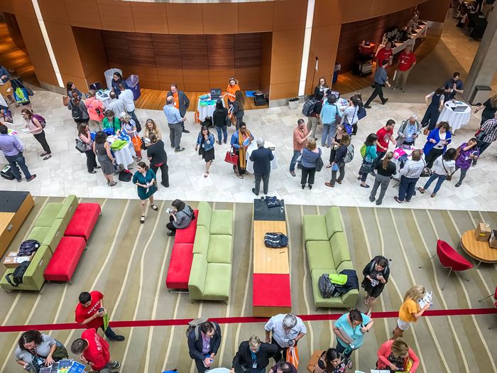 Shot from above of lots of people in a lobby area