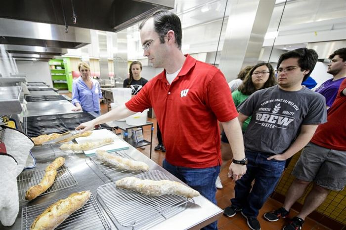 Nick Smith places loaves of bread onto drying racks