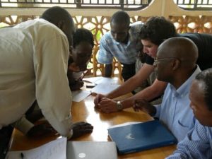 Researchers crowding around a table with papers