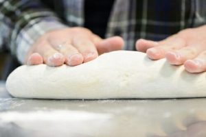 Samantha Milota rolls out bread dough