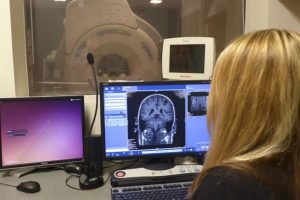 Sara John looking at an MRI image on a computer screen