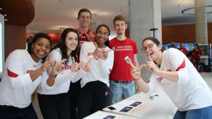 Six UW Students each making a W with their hands