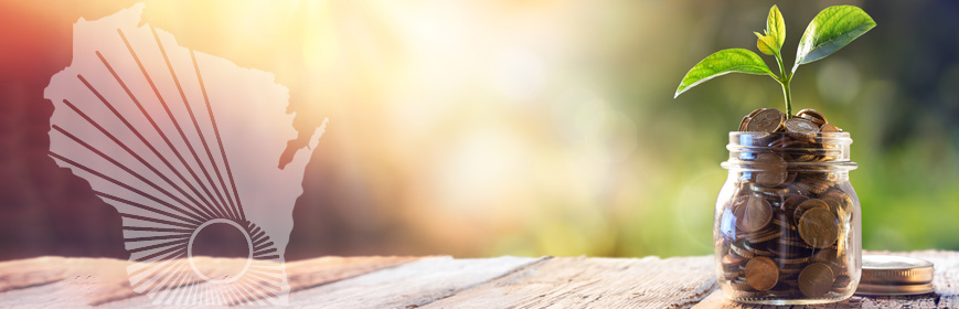 A small jar of pennies with a plant sprouting out of it, sitting on a table outside