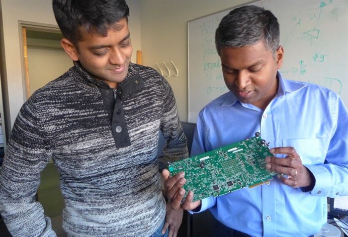 Two men inspecting a motherboard