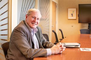 Professor Gerald Kulcinski sitting at a desk in a meeting room