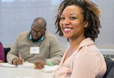 Woman sitting at a table smiling