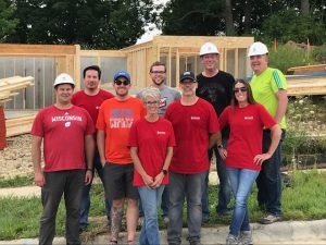 Group of WARF employees posing together at a housing construction site