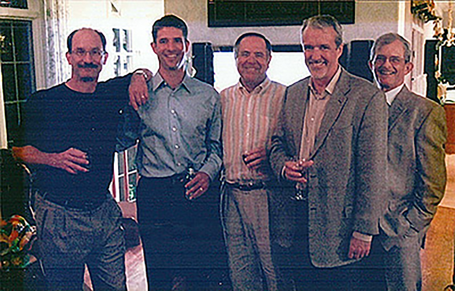 Five gentleman smile at the camera.