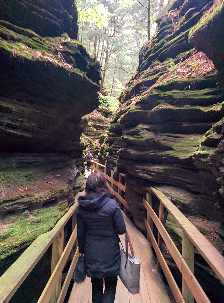 A woman walks a wooden walkway in the Wisconsin Dells